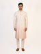 Man wearing a multi-color embroidered kurta and white pants, traditional Indian ethnic wear.
