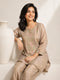 Woman wearing a shimmering grey embroidered kurta and matching pants, styled for a festive occasion.