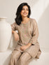 Woman wearing a shimmering grey embroidered kurta and matching pants, styled for a festive occasion.