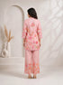 Woman wearing a pink floral print kurta with matching palazzo pants and lace trim.