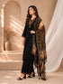 Woman wearing a black embroidered kurti and palazzo set with a colorful printed dupatta, seated on a chair.