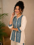 Woman wearing a cream kurta with blue paisley print, showcasing intricate embroidery and a band collar neckline.