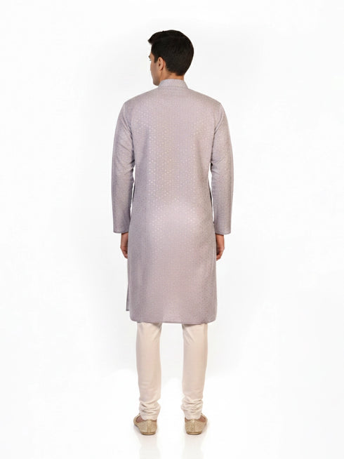 Man wearing a grey Kurta Pajama with a subtle geometric pattern and cream churidar pants.