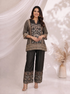 Woman wearing a black printed kurta with wide-leg pants, featuring floral motifs and a contrasting border.
