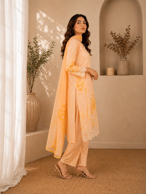 Woman wearing a yellow floral embroidered Kurti Set with lace trim and matching dupatta.