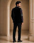 A classic black taxido suit, perfect for formal events, showcasing elegant tailoring and a sophisticated look.