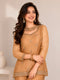 Woman wearing a mustard embroidered Sharara with intricate embellishments on the neckline and hem.