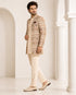 Man wearing an elegant beige Sherwani, showcasing intricate embroidery and a classic fit for formal events.