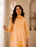 Woman wearing a yellow floral embroidered Kurti Set with lace trim and matching dupatta.