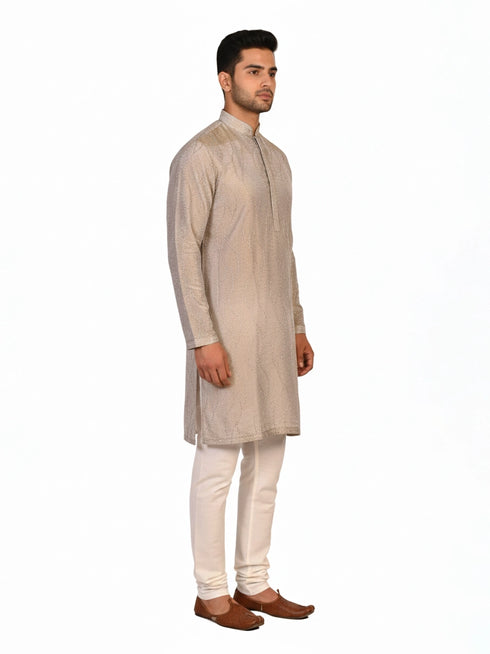 Man wearing a multi-color textured kurta with shimmering accents and cream pants, ready for festive occasions.