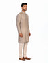 Man wearing a multi-color textured kurta with shimmering accents and cream pants, ready for festive occasions.