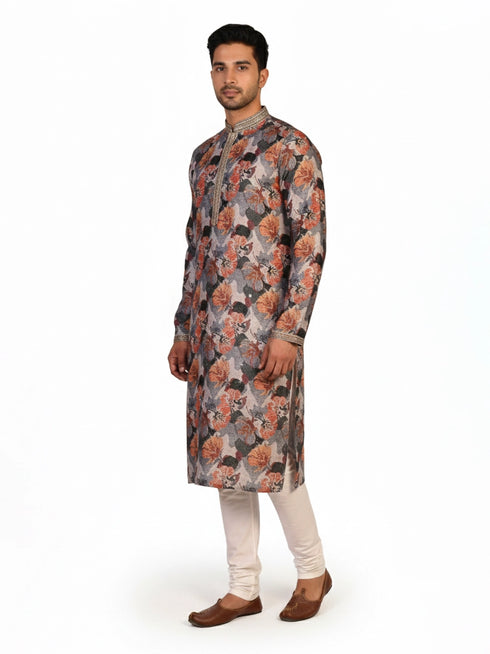 Man wearing a multi-color floral print kurta with an embellished neckline and cream churidar pants.