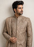 A man wearing an elegant Chikoo Sherwani, perfect for weddings and festive occasions.