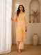 Woman wearing a yellow floral embroidered Kurti Set with lace trim and matching dupatta.