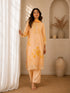 Woman wearing a yellow floral embroidered Kurti Set with lace trim and matching dupatta.