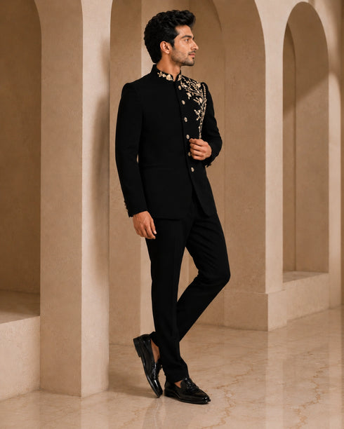 Man wearing a classic black Jodhpuri suit, a traditional Indian formal outfit.