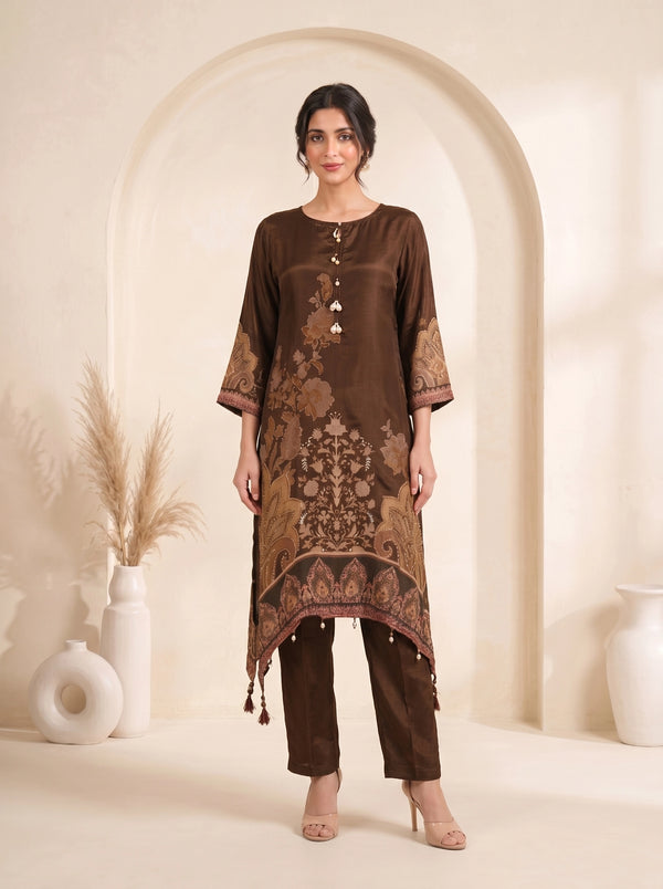 Woman wearing a brown printed kurti with pearl details and matching pants, styled for an elegant occasion.