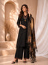 Woman wearing a black embroidered kurti and palazzo set with a colorful printed dupatta, seated on a chair.