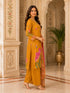 Woman wearing a mustard yellow kurta set with floral prints and palazzo pants, draped with a printed dupatta.