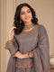 Woman wearing a pink embroidered choker neck Sharara with floral details on sleeves and hem.