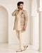 Man wearing an elegant beige Sherwani, showcasing intricate embroidery and a classic fit for formal events.