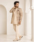 Man wearing an elegant beige Sherwani, showcasing intricate embroidery and a classic fit for formal events.
