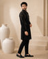 Man wearing a stylish black Indo-Western suit, showcasing intricate details and a modern fit.