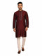 Man wearing a maroon kurta with a diamond pattern and embroidered neckline, paired with cream pants.