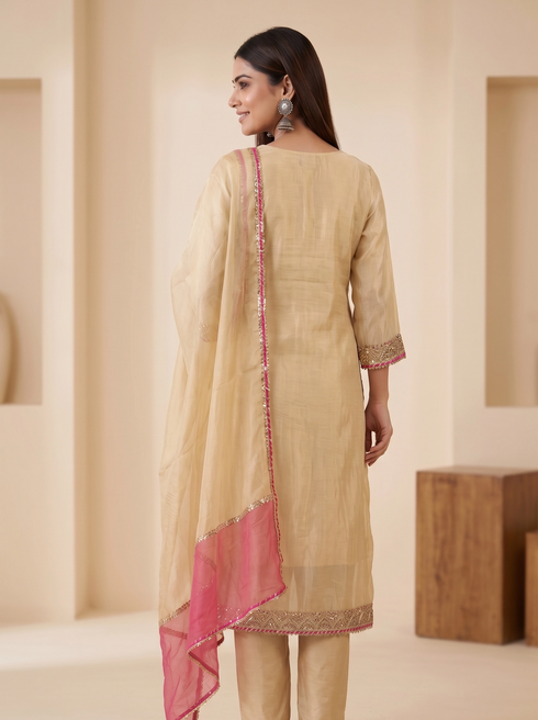 Elegant cream embroidered kurta set with pink trim dupatta and matching pants, perfect for festive occasions.