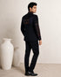 Man wearing an elegant navy blue Jodhpuri suit, a traditional Indian formal outfit.