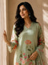 A woman models a green floral embroidered Kurti Set with matching pants and a dupatta, featuring delicate lace trim.