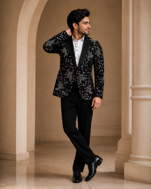 A classic black taxido suit, perfect for formal events, showcasing elegant tailoring and a sophisticated look.