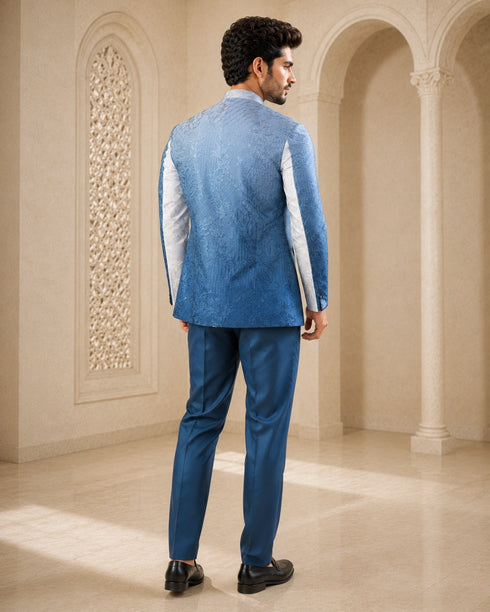 A woman wearing an elegant teal Indowestern outfit, showcasing intricate details and a flattering silhouette.