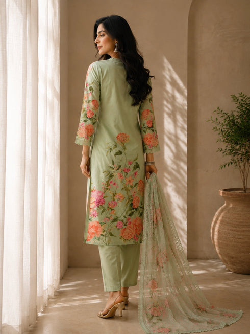 A woman models a green floral embroidered Kurti Set with matching pants and a dupatta, featuring delicate lace trim.