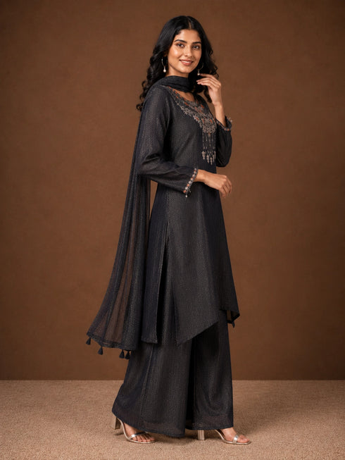 Woman wearing a Fawn sparkling embroidered Sharara with intricate floral details on the neckline and cuffs.