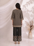 Woman wearing a black printed kurta with wide-leg pants, featuring floral motifs and a contrasting border.