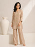 Woman wearing a shimmering grey embroidered kurta and matching pants, styled for a festive occasion.