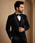 A classic black taxido suit for men, showcasing a sharp silhouette and elegant formal wear.