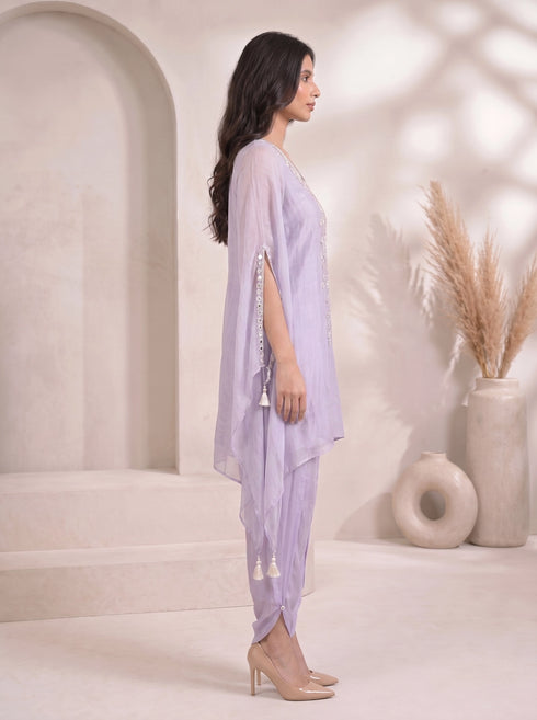 Woman wearing a light purple embroidered kaftan with split sleeves and matching dhoti pants, adorned with mirror work.