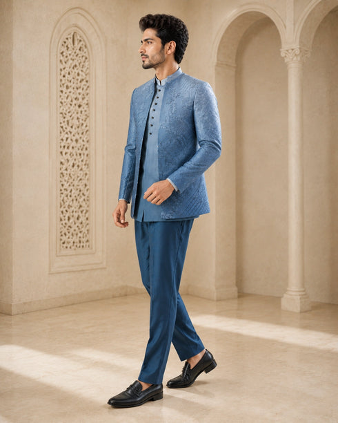 A woman wearing an elegant teal Indowestern outfit, showcasing intricate details and a flattering silhouette.