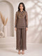 Woman wearing a grey sheer co-ord set with a detailed gold beaded and sequined neckline and wide-leg pants.