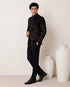 Man wearing an elegant navy blue Jodhpuri suit, a traditional Indian formal outfit.