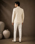 Man wearing a classic white Jodhpuri suit, perfect for formal Indian events and celebrations.