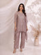 Woman wearing an onion-colored kaftan top with sequin embellishments and matching pants, styled for a festive occasion.