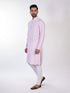 Man wearing a pink chikankari kurta with white churidar pants and brown embellished juttis.
