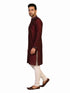 Man wearing a maroon kurta with a diamond pattern and embroidered neckline, paired with cream pants.