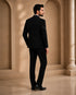 A classic black taxido suit for men, showcasing a sharp silhouette and elegant formal wear.