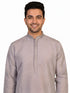 Man wearing a grey Kurta Pajama with a subtle geometric pattern and cream churidar pants.