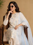 Woman wearing a blue floral print Kurti Set with a sheer blue dupatta, seated in a chair.