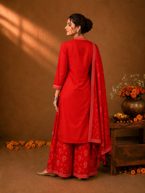 Woman in a Rani red printed Kurti Set with a dupatta, showcasing intricate patterns and elegant drape.